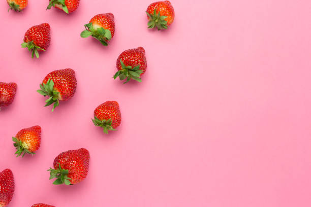 istock Ripe juicy strawberries on a pink background. Pattern, Fresh berry flat lay. Creative Minimal food concept. Copy space 1222206179