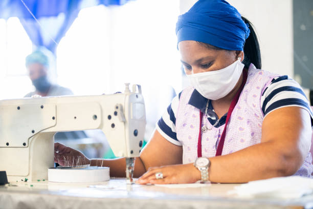 istock Seamstress concentrating on face mask production 1222207139