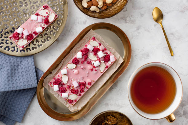 istock handmade pink chocolate bar with marshmallows, raspberry and almond lying on the table near a cup of tea 1222207603