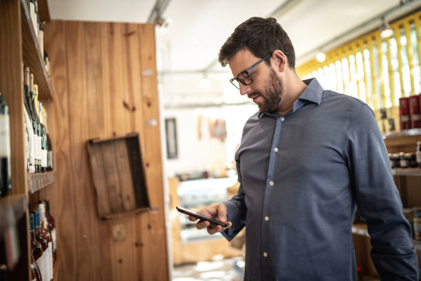 istock Mid adult man customer buying using mobile phone at store 1222208946