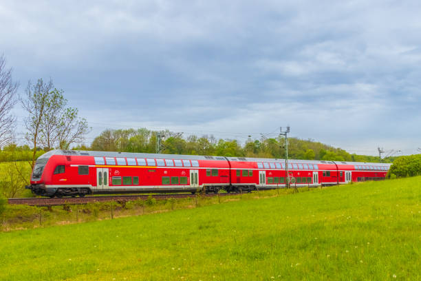 Bombardier double-deck bilevel rail car train of Deutsche Bahn, a german railway company on a sunny summer day near Ulm, Germany Ulm, Germany - April 30, 2020: Bombardier double-deck bilevel rail car train of Deutsche Bahn, a german railway company on a sunny summer day near Ulm, Germany. deutsche bahn stock pictures, royalty-free photos & images