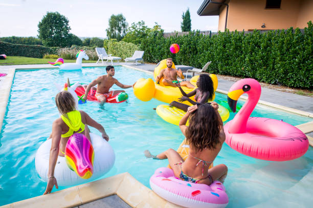 istock Friends having fun in a swimming pool 1222210264