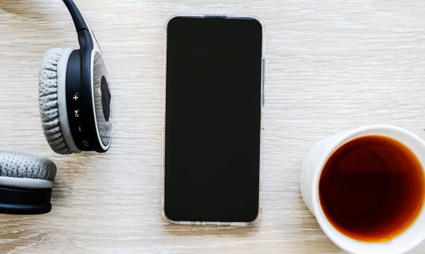 istock Headphones, telephone and tea on the table. We work at home. Work in quarantine. 1222210652
