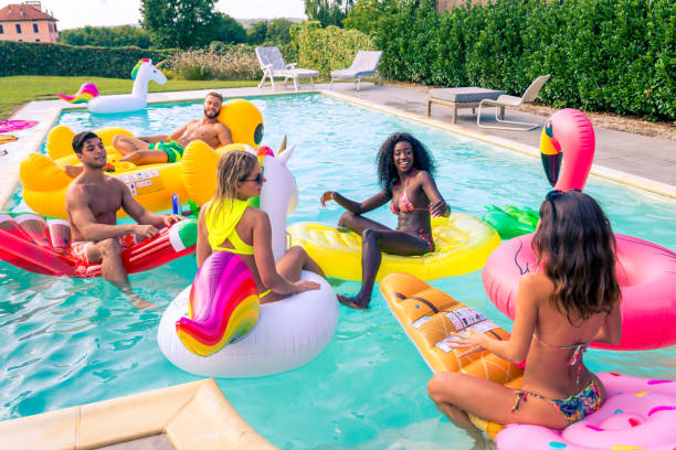 istock Friends having fun in a swimming pool 1222210732