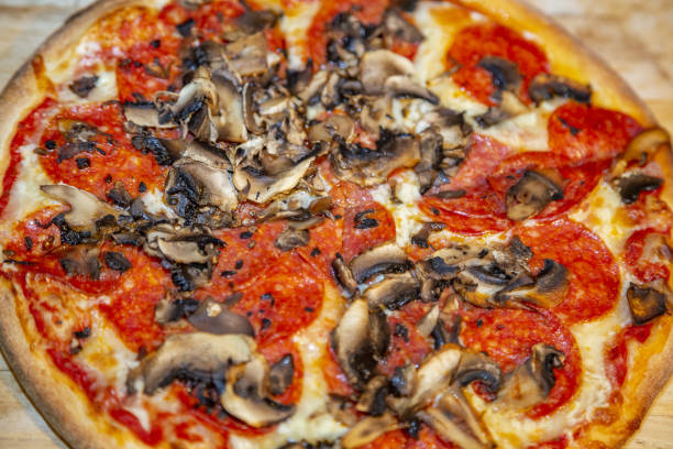 istock Freshly baked appetizing pizza with cheese and spices 1222214223