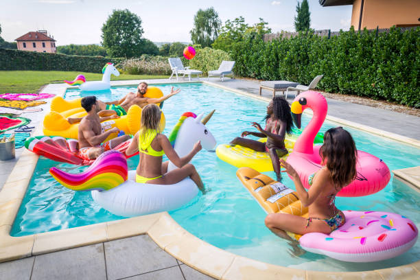 istock Friends having fun in a swimming pool 1222214301