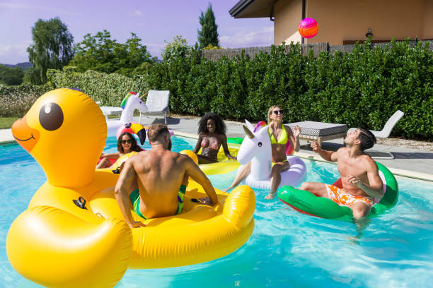 istock Friends having fun in a swimming pool 1222215882