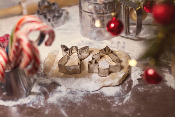 istock cookie cutters herringbone and angel lie on raw dough with spices for gingerbread on table covered with flour and candy, christmas 1222215963