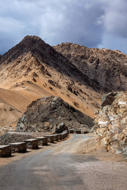 istock Road in Himalayas with mountains 1222216219