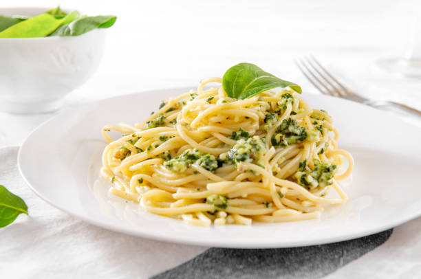 istock pasta with spinach and cheese on a plate , fresh spinach leaves, spaghetti 1222217377