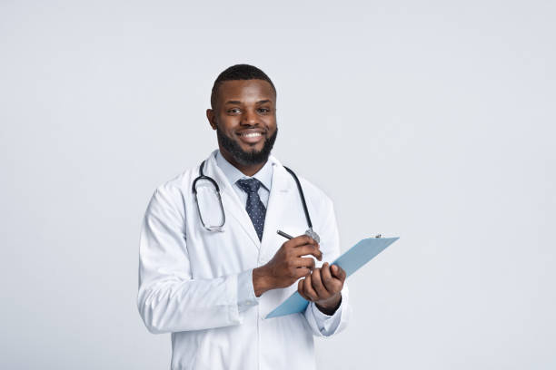 istock Smiling african therapist filling up medical forms 1222218972