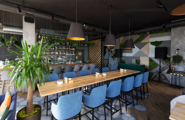 istock Cute restaurant interior with sofas and wooden tables 1222219711