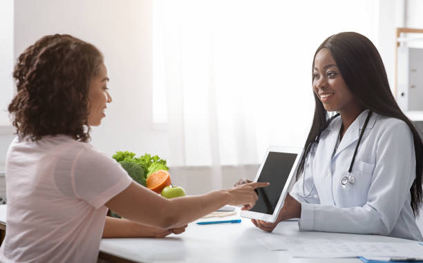 istock Woman nutritionist using digital tablet in office, making patient's anamnesis 1222219738