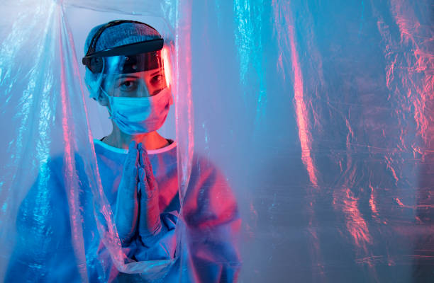 istock Female medical stuff behind isolated curtain 1222220420