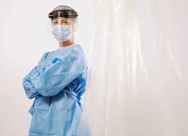 Woman doctor behind isolated curtain. The are real hero.