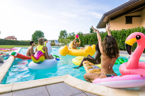 istock Friends having fun in a swimming pool 1222221799