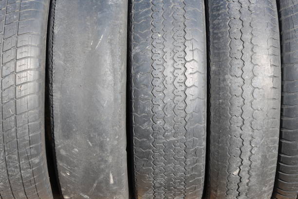 istock worn out bald old car tire close-up 1222221809
