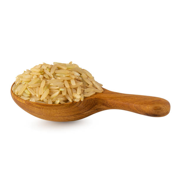 istock Brown rice in a wooden spoon isolated on white background 1222222872