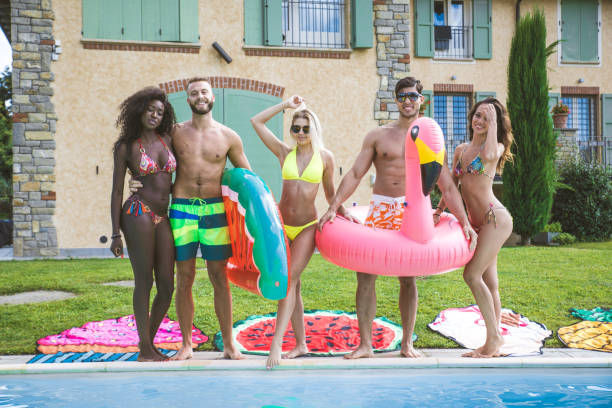 istock Friends having fun in a swimming pool 1222223034
