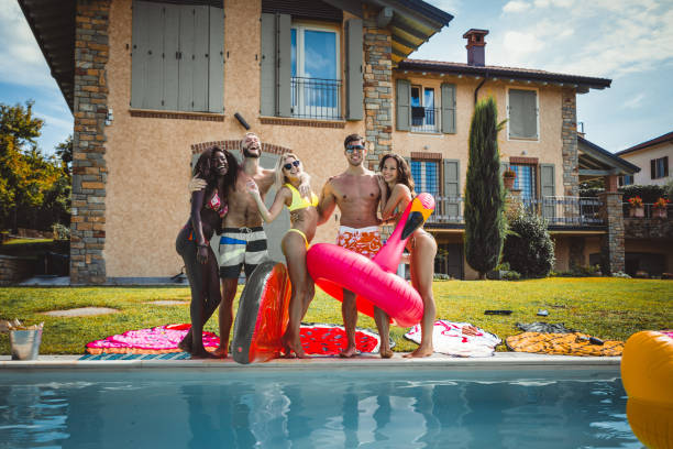 istock Friends having fun in a swimming pool 1222223340