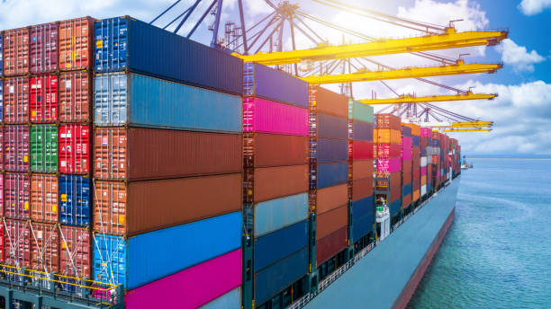 istock Container ship unloading in deep sea port, Global business logistic import export freight shipping transportation oversea worldwide container ship, Container vessel loading cargo cargo freight ship. 1222227173