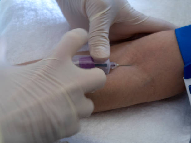 istock nurse  pricking needle syringe in the arm patient 1222227698