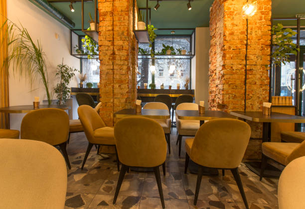 istock Cute restaurant interior with sofas and wooden tables 1222228675