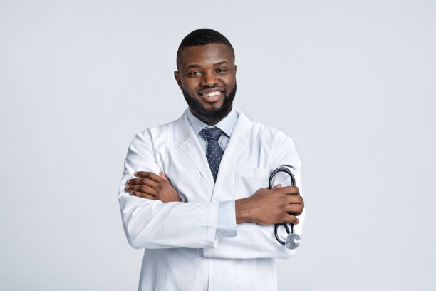 istock Confident smiling african medical doctor over white studio background 1222228798