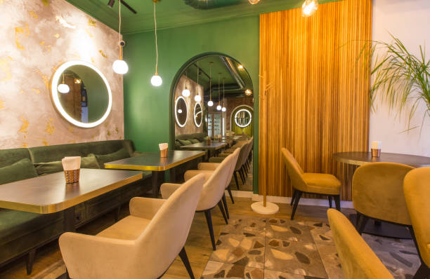 istock Modern restaurant interior with tables and sofas, light green walls 1222228876