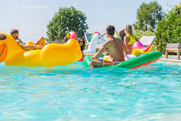 istock Friends having fun in a swimming pool 1222228913