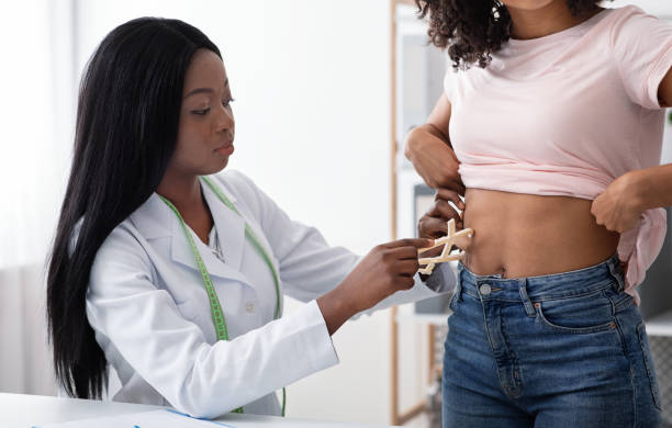 istock Dietary doctor checking body fat index with caliper 1222229151