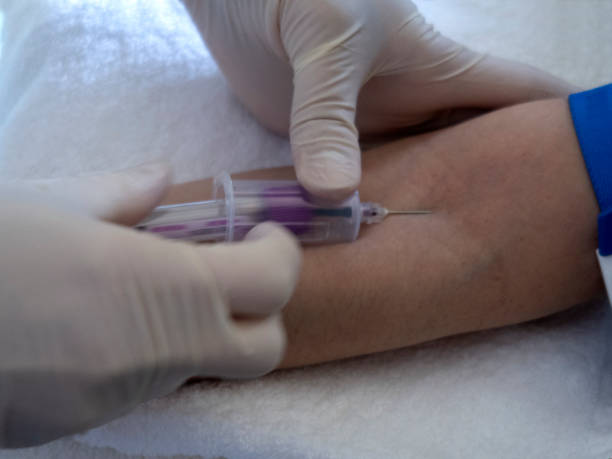 istock nurse  pricking needle syringe in the arm patient 1222229227