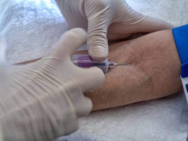 istock nurse  pricking needle syringe in the arm patient 1222230253