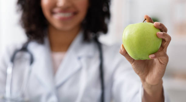 istock Green apple in doctor hand, close up 1222230400