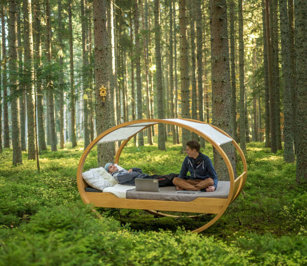 istock Young men work on computers on bed in autumnal forest 1222232244