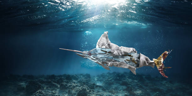 Trash Underwater In Ocean In Shape Of Marlin Swordfish A conceptual image showing one of the most common types of trash found in the ocean - cigarettes, plastic bottles, plastic bags, straws, food packaging, ring pull and plastic cutlery - in the shape of a marlin or swordfish, falling to the bottom of the ocean. Set underwater with copy space. plastic pollution photos stock pictures, royalty-free photos & images