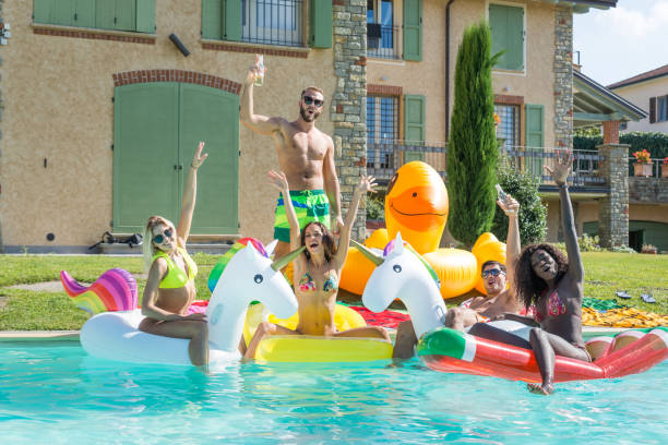 istock Friends having fun in a swimming pool 1222239440