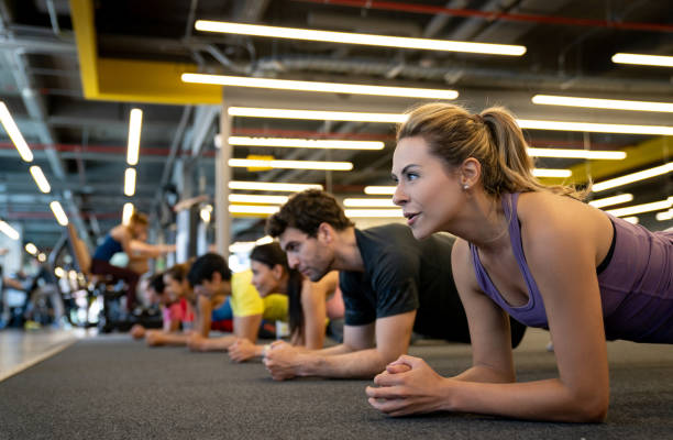 istock Woman at the gym doing a plank in a class 1222239624