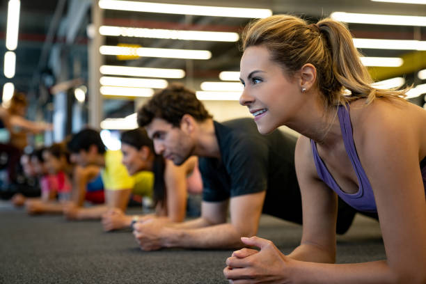 istock People exercising at the gym and looking happy doing planks 1222239643