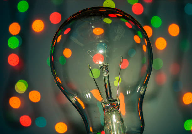 istock Light bulb on multicolored lights background, I have an idea !! 1222241119