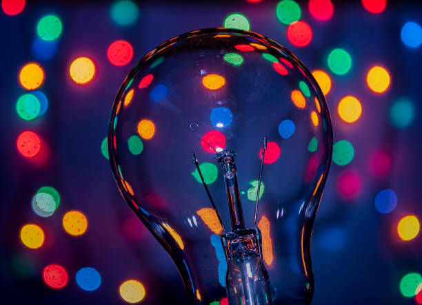 istock Light bulb on multicolored lights background, I have an idea !! 1222241175
