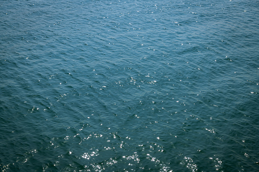 Blue sea with ribbed textured waves, top view