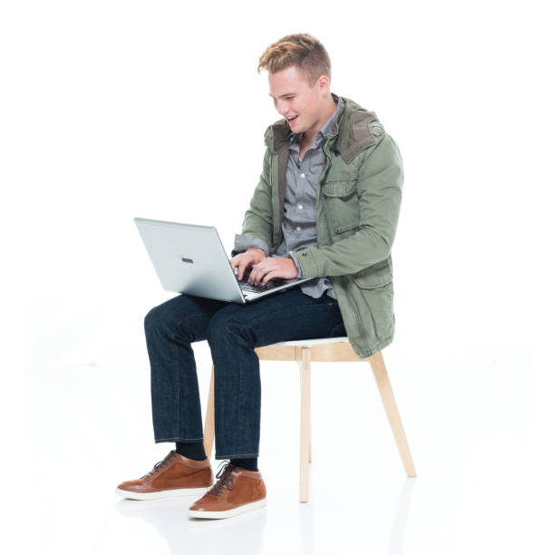 istock Caucasian boys resting in front of white background wearing shirt and using computer 1222242211