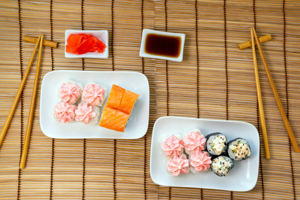istock Philadelphia Roll with cream cheese, wrapped with fresh salmon plastics top view, Lava Roll with cream cheese and salmon, poured with Lava sauce 1222242659