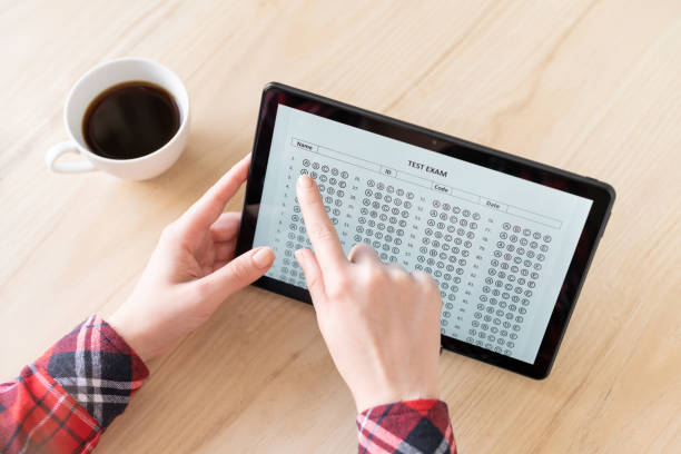 istock Online exam. Woman student testing exercise. Examination test on the tablet for school, university. multiple choice answer sheet. Home school, online study. Tutorial 1222242830