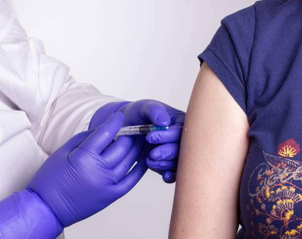 istock A medical worker in a white coat vaccinates a patient in the shoulder 1222243796