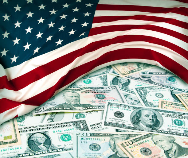 istock USA flag and cash 1222243872