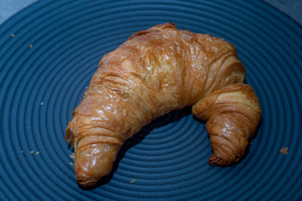istock fresh golden croissant on dark background 1222244251