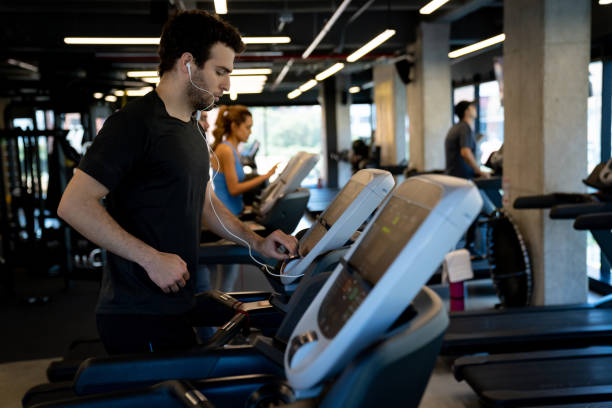 istock Athletic man getting ready for a run on the treadmill 1222244270