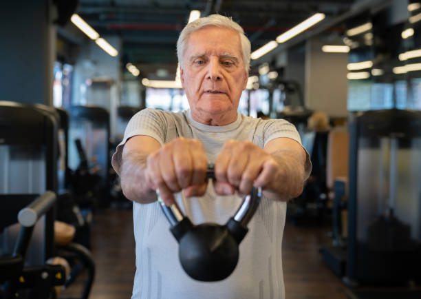 istock Senior man working out at the gym using a kettlebell 1222244276